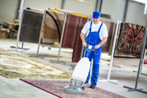 man deep cleaning a carpet